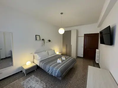 a bedroom with a bed and a flat screen tv at Flaminia Apartment - Metro A in Rome