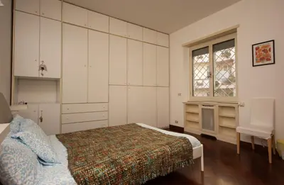 a bedroom with a bed and a window at Peck House in Marconi San Paolo in Rome