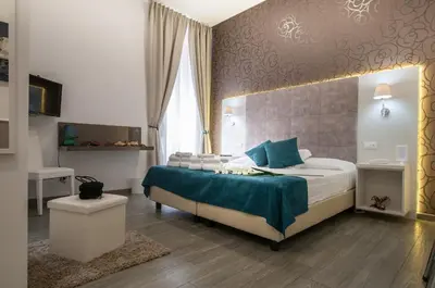 a bedroom with a king sized bed and a window at Elenoire Rooms & Suite in Rome