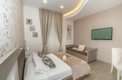 a hotel room with a bed and a couch at Elenoire Rooms & Suite in Rome
