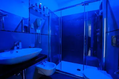 a bathroom with a sink and a glass shower at Elenoire Rooms & Suite in Rome