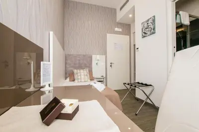 a room with a bed and a table with a book at Elenoire Rooms & Suite in Rome