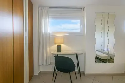 a small table and chair in a room with a window at Terrazza San Pietro vicino metro A in Rome