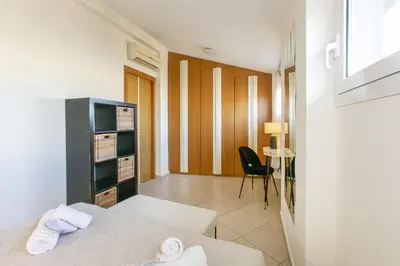 a hotel room with a bed and a chair at Terrazza San Pietro vicino metro A in Rome