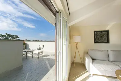 a living room with a couch and a view of the water at Terrazza San Pietro vicino metro A in Rome