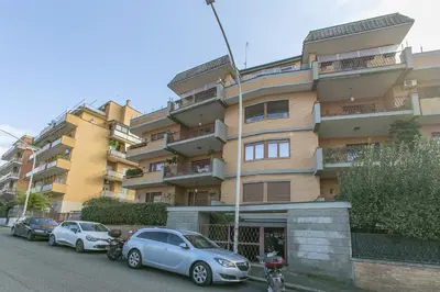 a group of cars parked in front of a building at Terrazza San Pietro vicino metro A in Rome