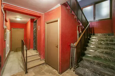 a staircase in a building with red walls at Terrazza San Pietro vicino metro A in Rome