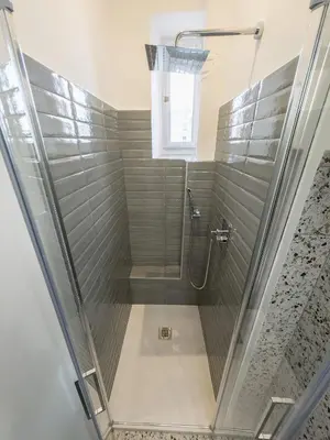 a shower with a glass door in a bathroom at Colosseum Charme in Rome