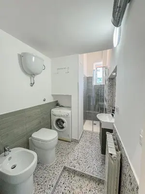 a bathroom with a toilet and a sink and a shower at Colosseum Charme in Rome