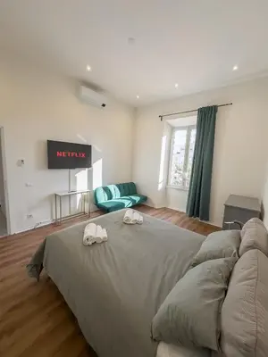 a bedroom with a large bed with two towels on it at Colosseum Charme in Rome
