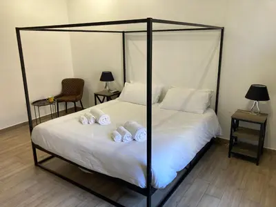 a bedroom with a four poster bed with white pillows at Trastevere Home Garibaldi 14 in Rome