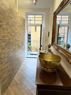 a bathroom with a bowl sink and a mirror at Trastevere Home Garibaldi 14 in Rome