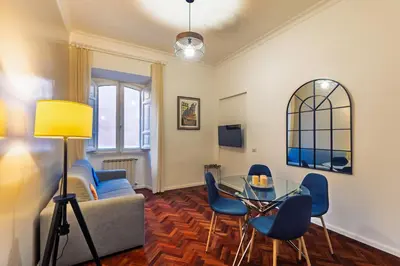 a living room with a couch and a glass table at Domus Flavia Monti in Rome