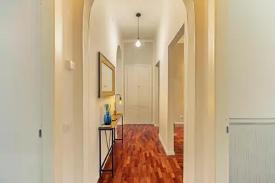a hallway with a hallway leading into a room with wood floors at Domus Flavia Monti in Rome
