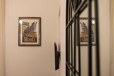 a door with two framed pictures on a wall at Domus Flavia Monti in Rome
