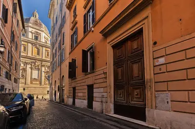 an alley with buildings and a car parked on a street at Domus Flavia Monti in Rome