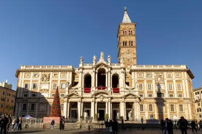 a large building with a clock tower and a christmas tree at Domus Flavia Monti in Rome