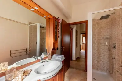 a bathroom with a sink and a tub and a shower at Roots of Rome Apartment in Rome
