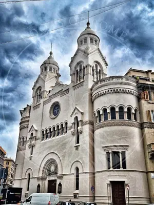 a large white building with a clock on it at Roots of Rome Apartment in Rome