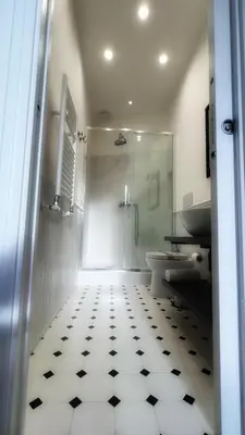 a bathroom with a shower and a toilet and a tiled floor at Dome View in Rome