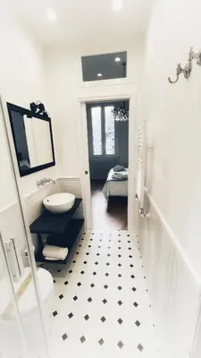 a white bathroom with a sink and a toilet at Dome View in Rome