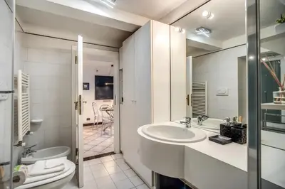a white bathroom with a sink and a toilet at Navona, 3 bedrooms, unique and spectacular view in Rome