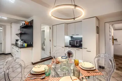 a dining room with a table and chairs in a kitchen at Navona, 3 bedrooms, unique and spectacular view in Rome