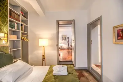 a bedroom with a bed and a lamp and a hallway at Navona, 3 bedrooms, unique and spectacular view in Rome