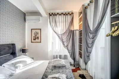 a bedroom with a bed and a window at Navona, 3 bedrooms, unique and spectacular view in Rome