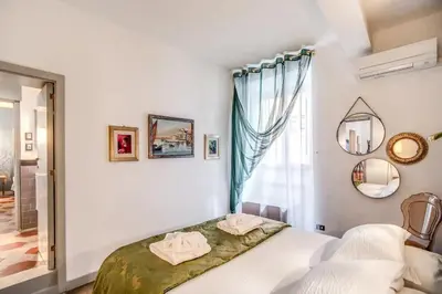 a bedroom with a bed and a window at Navona, 3 bedrooms, unique and spectacular view in Rome