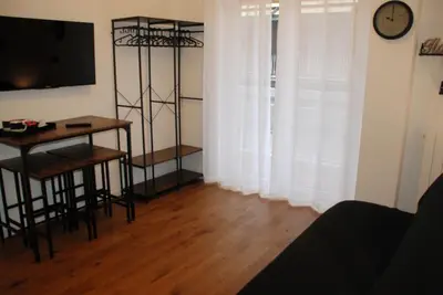 a living room with a table and a television and a desk at Viva la vida in Rome in Rome