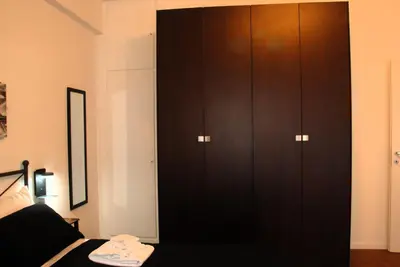 a bedroom with a black cabinet and a black couch at Viva la vida in Rome in Rome