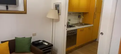 a kitchen with a couch and a table in a room at Bijoux de Rome Campo dei Fiori Apart in Rome