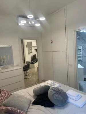 a bedroom with a bed with pillows on it at Dama Maria Elena - 1 min walk to Valle Aurelia Metro in Rome