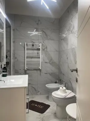a bathroom with a toilet and a sink at Dama Maria Elena - 1 min walk to Valle Aurelia Metro in Rome