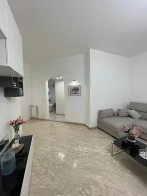 a living room with a couch and a table at Dama Maria Elena - 1 min walk to Valle Aurelia Metro in Rome