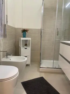 a bathroom with a shower and a toilet and a sink at Dama Maria Elena - 1 min walk to Valle Aurelia Metro in Rome