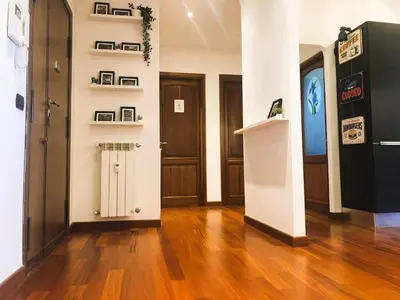 a room with a hallway with wooden floors and doors at Urbanhome, ready to visit Rome! in Rome