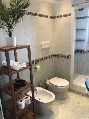 a bathroom with a toilet and a sink at Urbanhome, ready to visit Rome! in Rome