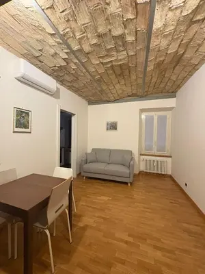 a living room with a table and a couch at Guest House David San Lorenzo in Rome