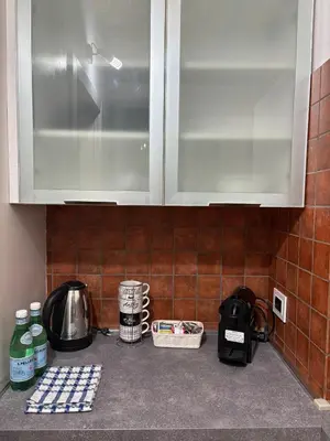 a kitchen counter with a sink and a cupboard at Guest House David San Lorenzo in Rome