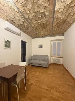 a living room with a table and a couch at Guest House David San Lorenzo in Rome