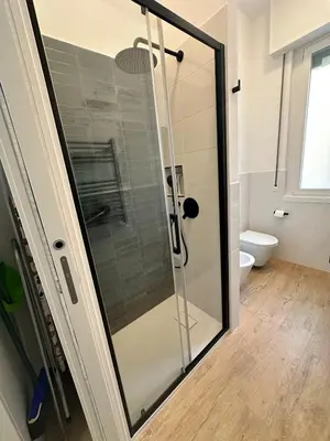a shower with a glass door in a bathroom at Charming House Tuscolana - Roma in Rome