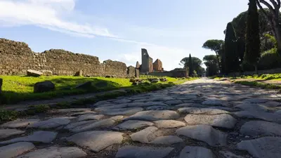 a cobblestone street in front of a castle at Charming House Tuscolana - Roma in Rome