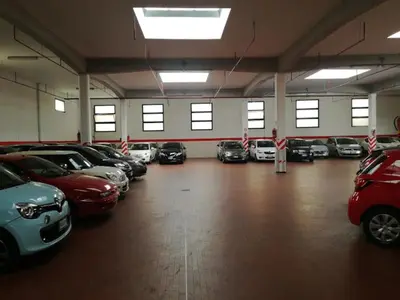a garage with a lot of cars parked in it at Charming House Tuscolana - Roma in Rome