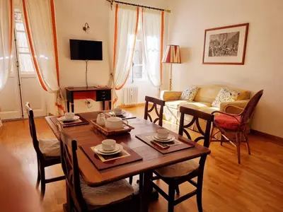 a living room with a table and a couch at Via Veneto Cosy House in Rome