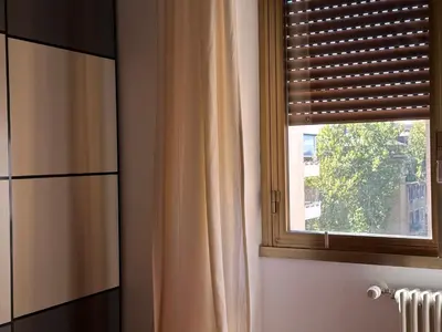 a window with a curtain in a room at La dolce vita in Rome - Guest House in Rome