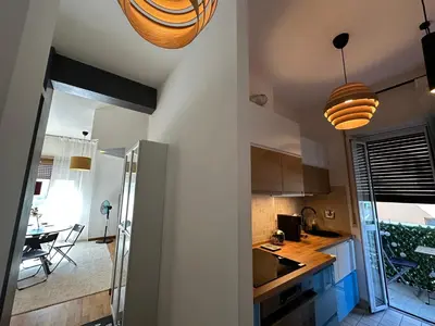 a kitchen with two pendant lights and a dining room at La dolce vita in Rome - Guest House in Rome