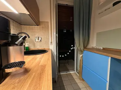 a kitchen with a counter and a blue counter top at La dolce vita in Rome - Guest House in Rome