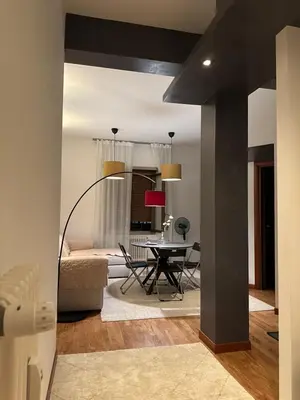 a living room with a table and a dining room at La dolce vita in Rome - Guest House in Rome